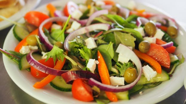 Home A vibrant Mediterranean salad featuring fresh vegetables, olives, and feta cheese for a healthy meal.